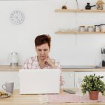 Mujer frente a una computadora revisando su registro crediticio en el Veraz